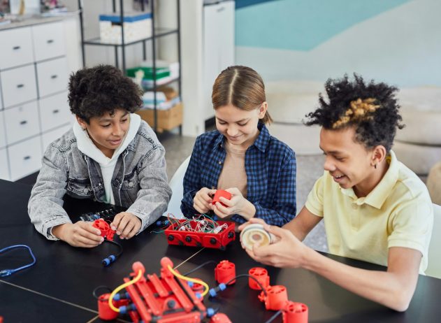 Children collaborating on a robotics project, showcasing teamwork and STEM learning indoors.
